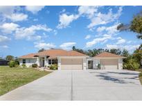 Charming single-story home featuring a three-car garage and well-manicured lawn at 1730 Hudson St, Englewood, FL 34223
