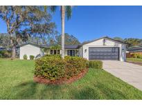 Charming single-story home featuring a well-manicured lawn and inviting curb appeal at 2846 Pheasant Run, Clearwater, FL 33759