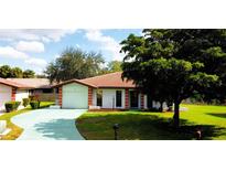 Charming single-story home with a well-manicured front lawn and a beautiful, mature shade tree at 3002 Vivienda Dr # 22, Bradenton, FL 34207