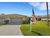 Charming single-story home featuring a well-manicured lawn and an attached one-car garage at 4348 Bowling Green Cir # 9, Sarasota, FL 34233