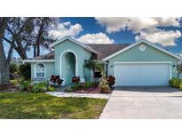 Charming one-story home with an attached two-car garage, front lawn, and mature landscaping at 5110 76Th E St, Bradenton, FL 34203