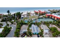 Charming coastal home near the beach featuring solar panels and lush tropical landscaping at 5802 De Palmas Ave, Holmes Beach, FL 34217