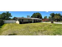 Charming single-story home featuring a well-maintained lawn and a partially bricked facade at 605 15Th Avenue E Dr, Palmetto, FL 34221