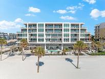 Beautiful beachfront condo building with large windows, pool, and beach access at 1035 Seaside Dr # 308, Sarasota, FL 34242