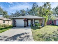 Charming single-story home with a well-manicured lawn and an attached single-car garage at 1410 24Th E Ave, Bradenton, FL 34208