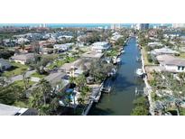 Aerial view of a waterfront community with canals, private docks, and stunning views of the coastline at 1633 Ridgewood Ln, Sarasota, FL 34231
