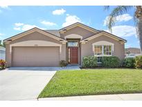 Charming single-story home featuring a well-manicured lawn, a two-car garage, and a welcoming front entrance at 4920 Breakwater Dr, Bradenton, FL 34203