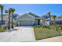 Charming single Gathering home featuring a two-car garage, manicured lawn, and beautiful landscaping at 5675 Equator Ct, Nokomis, FL 34275
