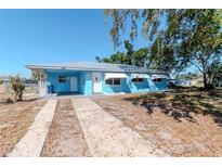 Charming single-story home featuring a covered porch, metal roof and a well-maintained front yard at 6604 Columbia Dr, Bradenton, FL 34207