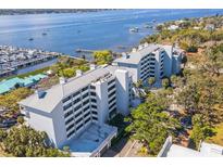 Stunning aerial view of waterfront condo building with marina access and beautiful water views at 1000 Riverside Dr # B102, Palmetto, FL 34221