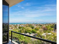 Balcony overlooking a residential area and a distant ocean view at 1211 Gulf Of Mexico Dr # 702, Longboat Key, FL 34228