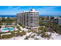 A luxury condo building boasts a beachside pool, lush landscaping, and ocean views at 1211 Gulf Of Mexico Dr # 702, Longboat Key, FL 34228