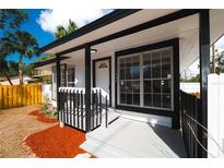 Inviting front exterior featuring white and black trim, enhanced by well-placed windows and a charming front porch at 1397 43Rd St, Sarasota, FL 34234