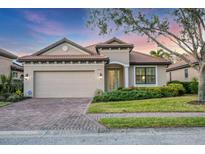 Charming single-story home featuring a brick driveway, well-maintained landscaping, and a neutral color palette at 3715 80Th E Dr, Sarasota, FL 34243