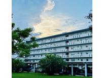 Multi-story condo building with balconies and covered parking on a lush green lawn at 4240 Ironwood Cir # 302A, Bradenton, FL 34209