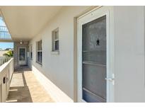 Hallway featuring secure unit entry door with glass and screen, and an exit at the end of the hall at 4240 Ironwood Cir # 302A, Bradenton, FL 34209