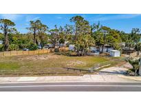 Cleared lot ready for your dream home with mature trees and wood and chain link fencing at 5061 Placida Rd # A, Englewood, FL 34224