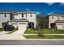 Charming townhomes featuring neutral color schemes, attached garages, and well-maintained landscaping at 5734 Archipelago St, Nokomis, FL 34275