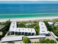 Stunning aerial view of beachfront condos, showcasing beautiful beaches and ocean views at 5757 Gulf Of Mexico Dr # 110, Longboat Key, FL 34228