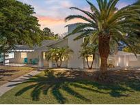 Stunning exterior view of a modern home with lush tropical landscaping and a beautiful walkway at 106 N Blvd Of The Presidents, Sarasota, FL 34236