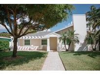 Charming single-story home featuring a manicured lawn and bright, neutral color scheme at 106 N Blvd Of The Presidents, Sarasota, FL 34236