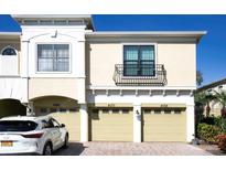 Townhome exterior showcasing garages and a balcony above one unit at 4070 Overture Cir # 461, Bradenton, FL 34209