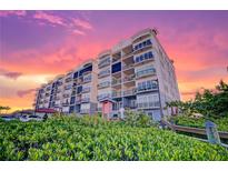 Beautiful condo building with sunset, balconies, landscaping, and luxurious architectural features at 501 Tamiami N Trl # 601, Venice, FL 34285