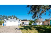 Charming single-story home boasts a well-maintained lawn and an attached two-car garage at 6306 32Nd W Ave, Bradenton, FL 34209