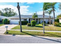 Charming one-story home with well-maintained lawn, mature landscaping, and a two car garage at 6722 Roxbury Dr, Sarasota, FL 34231