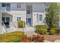 Inviting two-story condo featuring a private entrance, lush landscaping, and well-lit entryway at 803 Audubon Dr # 803, Bradenton, FL 34209