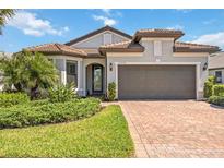 Beautiful single-Gathering home with a well-manicured lawn and a spacious two-car garage at 12370 Marsh Pointe Rd, Sarasota, FL 34238