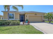 Charming single-Gathering home featuring a well-manicured lawn and a two-car garage at 15008 Trinity Fall Way, Bradenton, FL 34212
