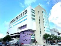 Exterior view of building with bright blue skies and street view at 1990 Main St # 10, Sarasota, FL 34236