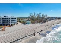 A beachfront property with stunning ocean views, sandy beach, and clear blue skies at 2350 N Beach Rd # 1B, Englewood, FL 34223