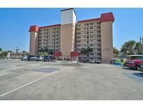 Multi-story building with ample parking, landscaped entry, and clearly labeled signage for Venice Costa Brava at 244 Saint Augustine Ave # 905, Venice, FL 34285