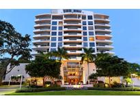 Upscale high-rise condo building with lush landscaping, elegant entrance, and numerous balconies at 401 S Palm Ave # 801, Sarasota, FL 34236