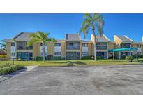 Charming condo with a well-maintained lawn and mature palm trees on a bright sunny day at 503 Albee Farm Rd # B6, Venice, FL 34285