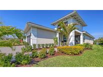 Beautiful single-Gathering home with a manicured lawn and lush tropical landscaping in a desirable neighborhood at 5209 Barnett Cir, Lakewood Ranch, FL 34211