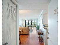 Inviting living room with wood floors and a view of the balcony at 5855 Midnight Pass Rd # 327, Sarasota, FL 34242