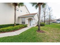 Charming front entrance featuring a tiled roof, manicured landscaping, and a welcoming walkway at 7157 Strand Cir # 24-102, Bradenton, FL 34203
