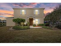 Inviting two-story home featuring a well-manicured lawn and neutral color palette at 14932 Amberjack Ter, Lakewood Ranch, FL 34202