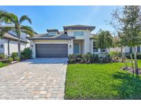 Charming single-Gathering home features a well-manicured lawn, beautiful landscaping, and a paved driveway at 16816 Seraphic Trl, Lakewood Ranch, FL 34211