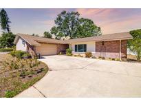 Charming single-story home with a brick and stucco exterior, mature landscaping, and a spacious driveway at 3802 24Th W Ave, Bradenton, FL 34205