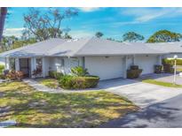 Charming single-story home featuring a well-manicured lawn and an attached garage at 4220 Center Pointe Ln # 21, Sarasota, FL 34233