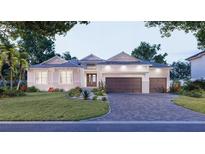 Beautiful single-story home featuring a three-car garage, manicured lawn, and a paver driveway at 5103 Windward Ave, Sarasota, FL 34242