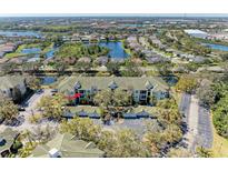 Scenic aerial view of condo complex surrounded by lush greenery, lakes and other residential areas in a beautiful neighborhood at 5160 Northridge Rd # 302, Sarasota, FL 34238