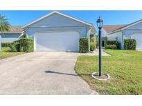 Charming single-story home with a well-maintained lawn and a two-car garage at 612 Ironwood Cir # 170, Venice, FL 34292