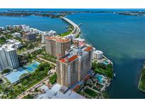 Stunning aerial view of waterfront condos, bay, and bridge offering luxury living and breathtaking scenery at 1111 Ritz Carlton Dr # 1704, Sarasota, FL 34236