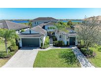 Beautiful single Gathering home with lush landscaping, two-car garage, and brick driveway at 5602 Tidewater Preserve Blvd, Bradenton, FL 34208