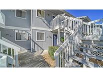 Exterior view of a two-story condo building with stairs leading to the second level at 6033 34Th W St # 35, Bradenton, FL 34210